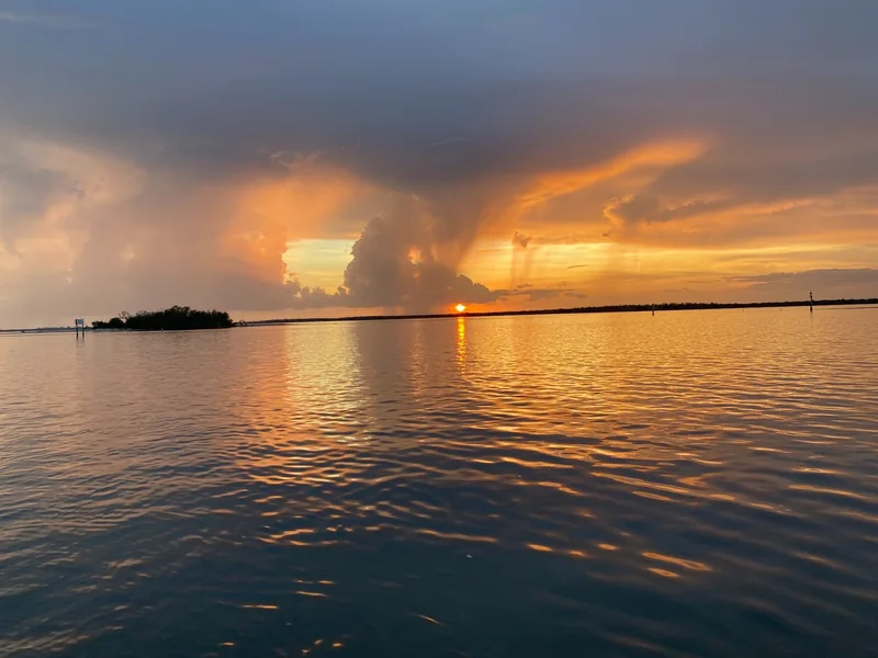 A dramatic rainstorm and orange sunset over Pine Island Sound