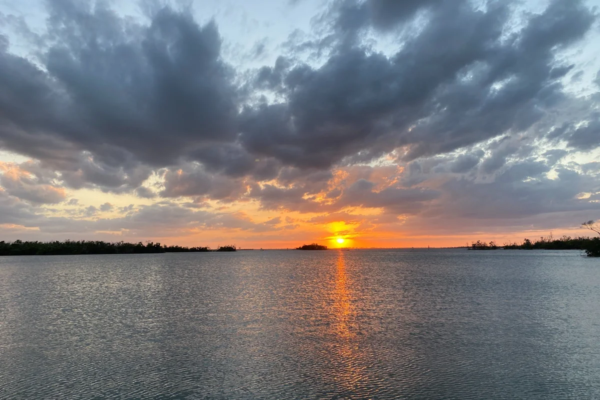Sunset over Pine Island Sound with dramatic clouds reflecting across the water