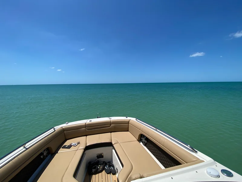 View over a boat bow toward open turquoise Gulf water