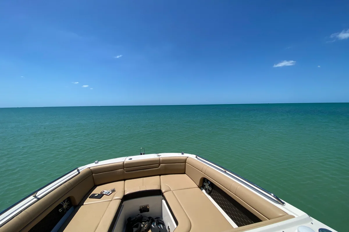 View over a boat bow toward open turquoise Gulf water