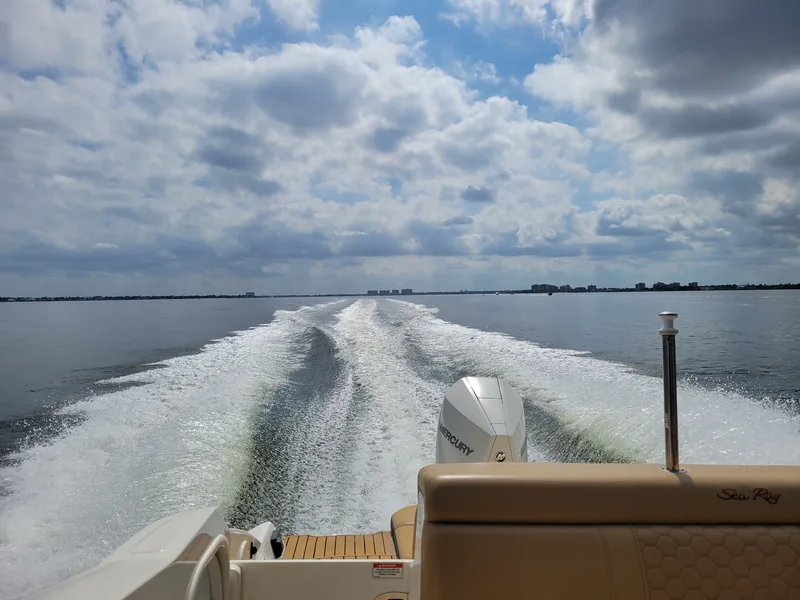 Boat wake cutting across open water near Cape Coral