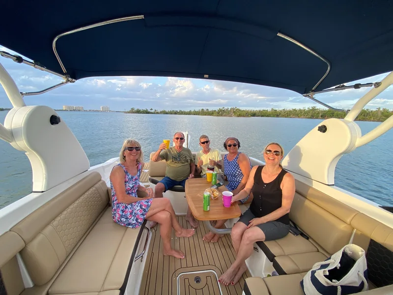 Friends relaxing together aboard a boat during a Southwest Florida sunset cruise