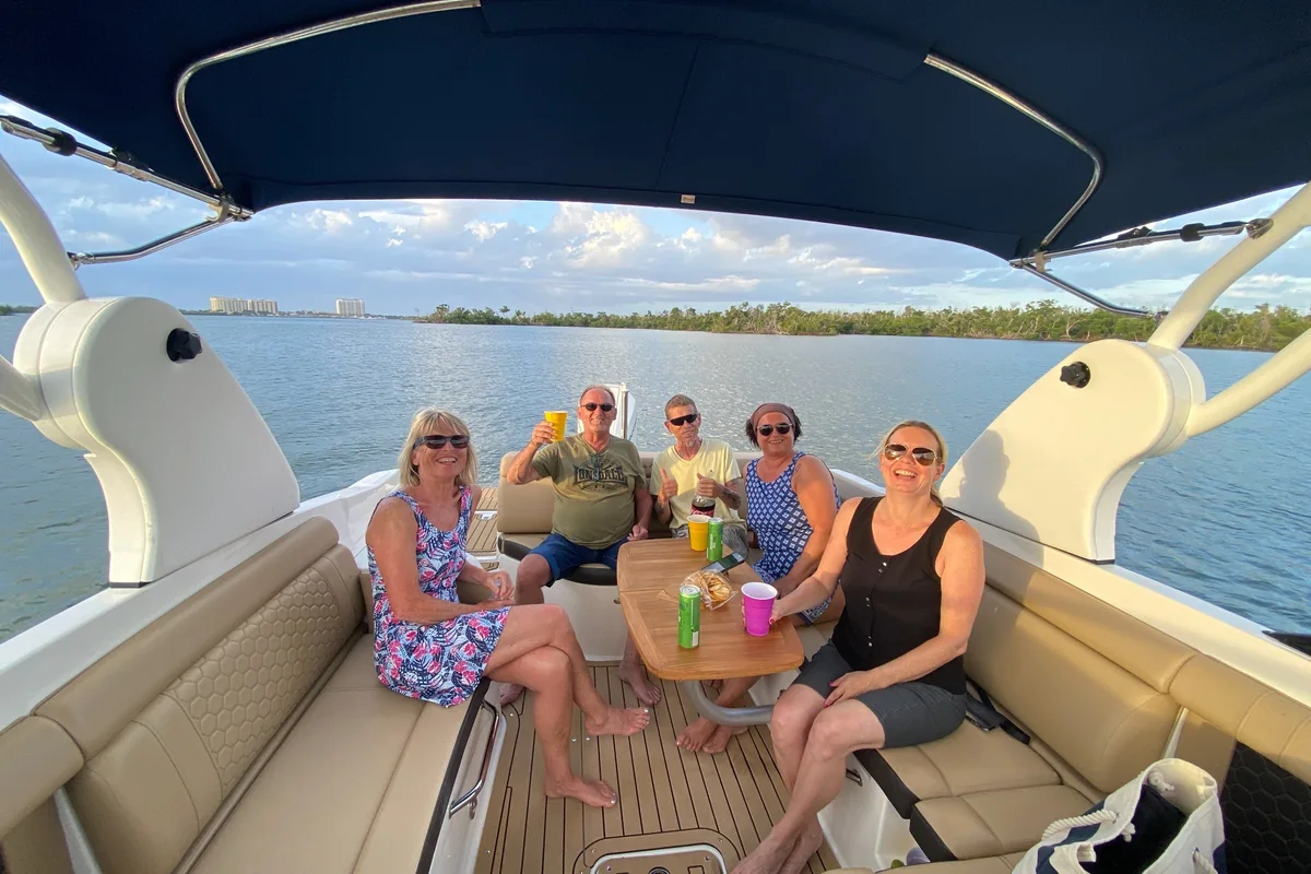 Friends relaxing together aboard a boat during a Southwest Florida sunset cruise