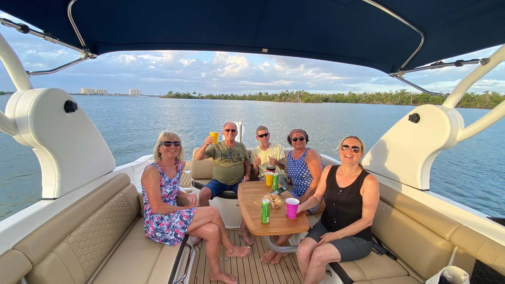 Friends gathered on a boat at sunset in Southwest Florida