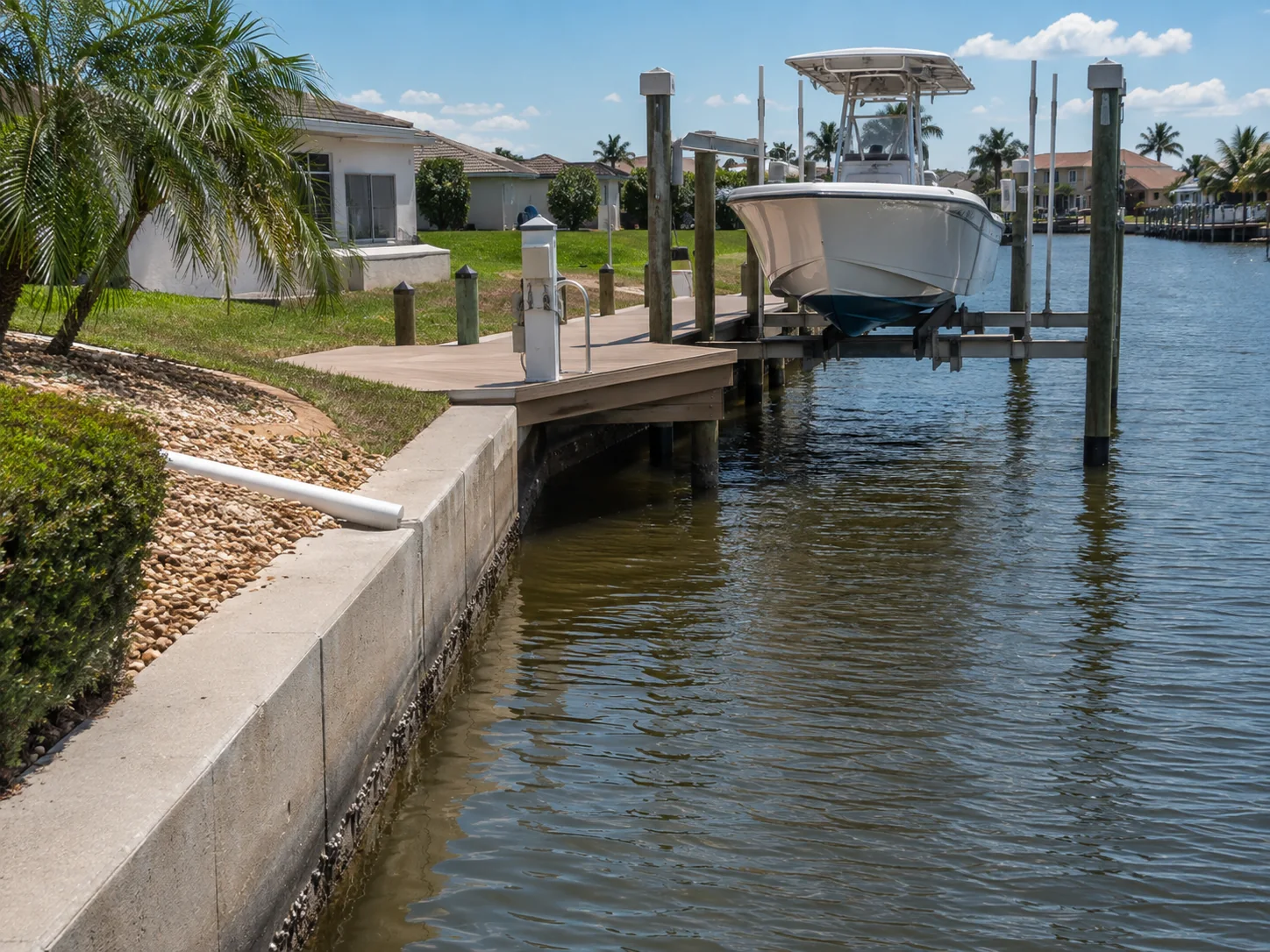 Concrete seawall, dock and boat lift at a Cape Coral Gulf-access property.