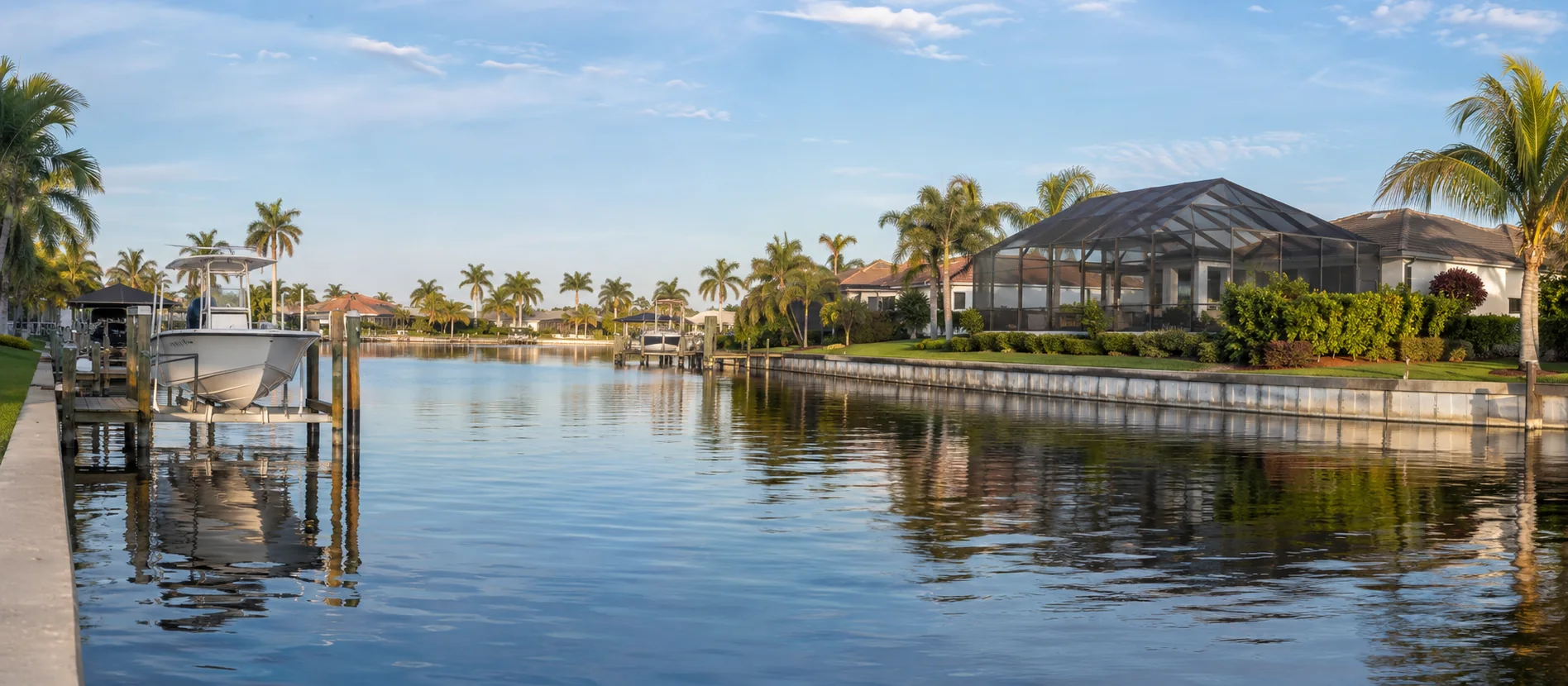 Cape Coral waterfront homes with docks, boat lifts and screened lanais along a Gulf-access canal.