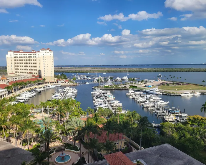 Aerial view of Tarpon Point Marina, waterfront residences and the Caloosahatchee River in Cape Coral.